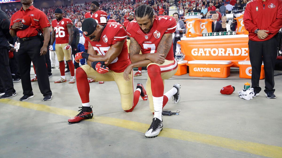 In this Sept. 12, 2016, file photo, San Francisco 49ers safety Eric Reid (35) and quarterback Colin Kaepernick (7) kneel during the national anthem before an NFL football game against the Los Angeles Rams in Santa Clara, Calif.