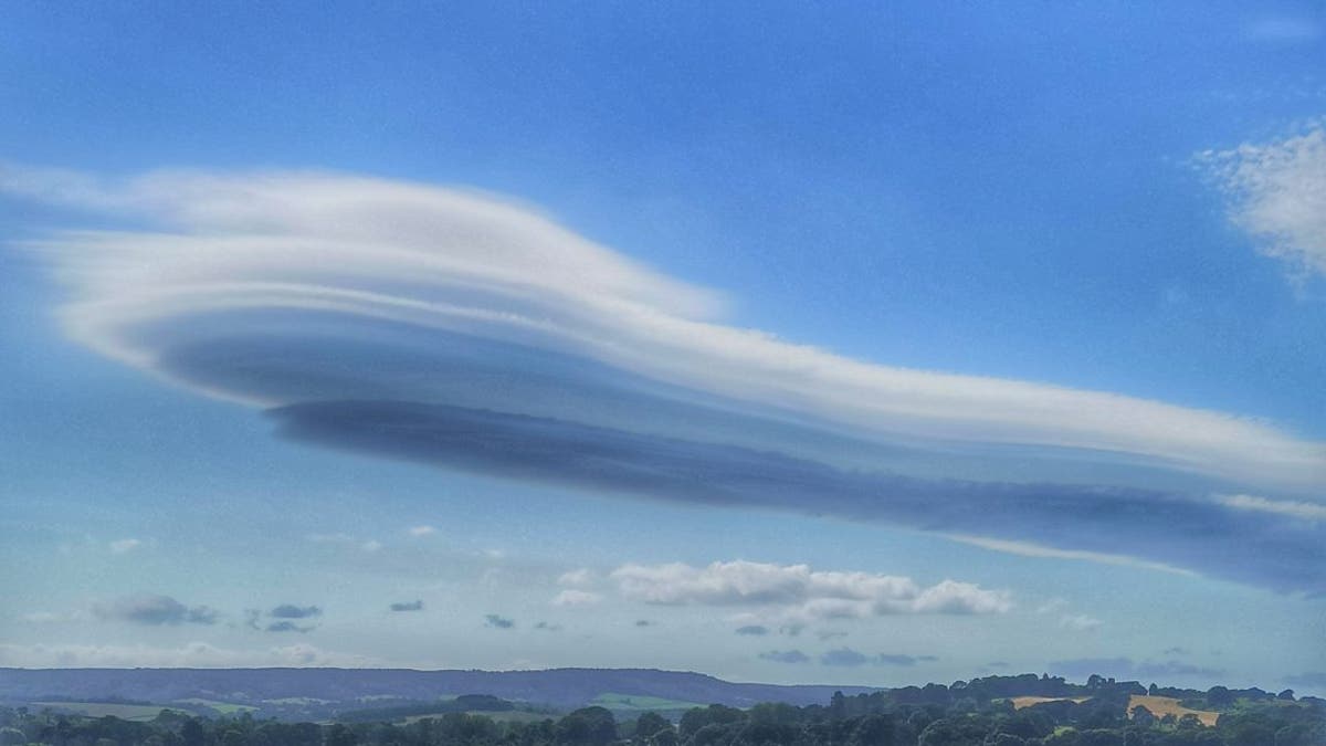 The images were taken by Stuart Woolger who noticed a "strange cloud formation" while cycling between Exmouth and Lympstone in Devon on June 22. (Credit: SWNS)