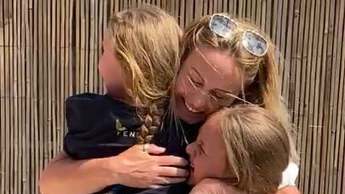 "Mummy! Mummy!" the girls shrieked in surprise, as the family embraced with hugs and tears after over two months apart.