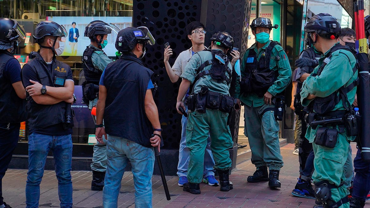 Police detain a person during a pro-democracy rally supporting human rights and to protest against Beijing's national security law in Hong Kong on Sunday. (AP Photo/Vincent Yu)