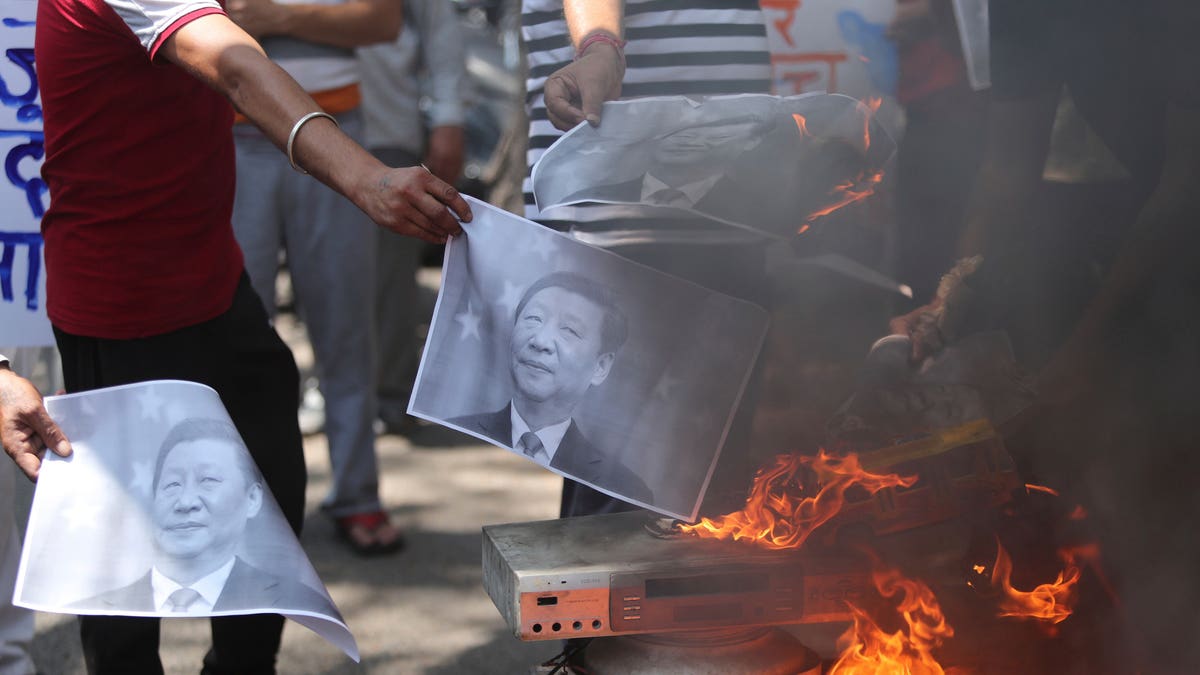 Indians burn photos Xi Jinping