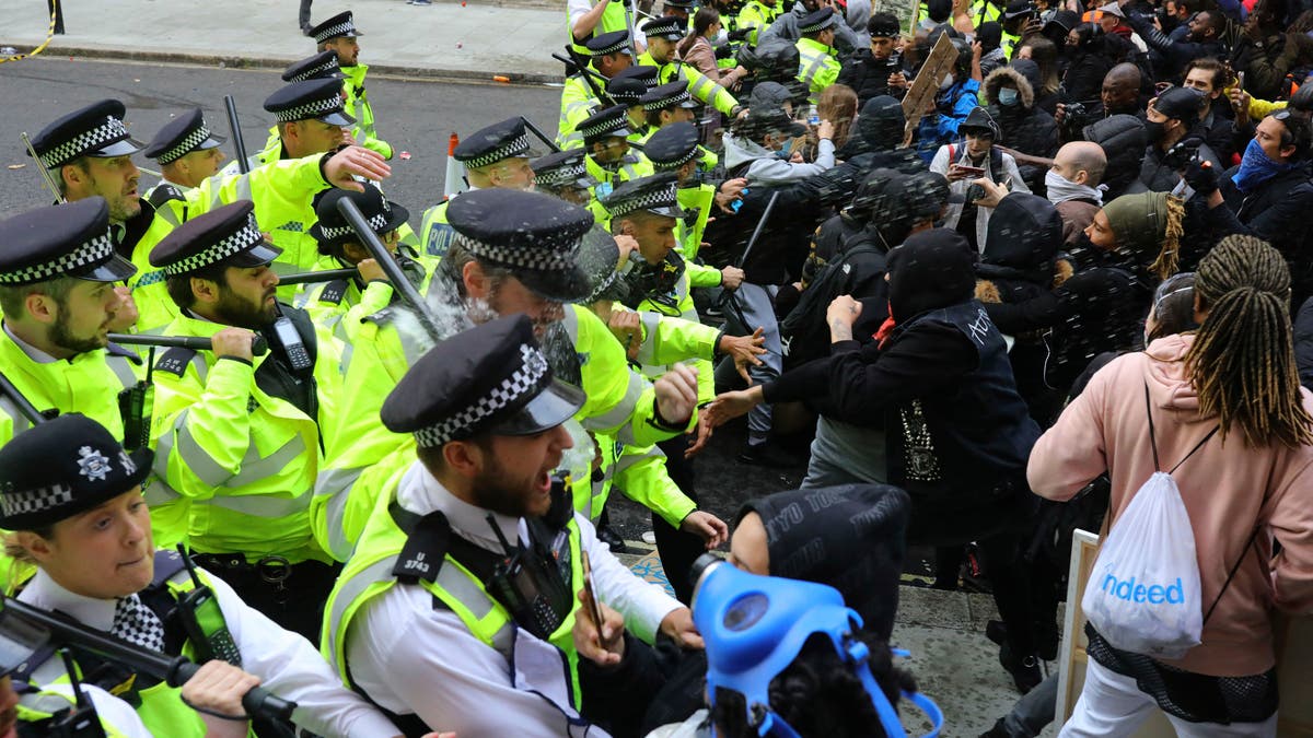 Police clash with protesters during a Black Lives Matter protest rally in Westminster, London, on Sunday. (AP/PA)