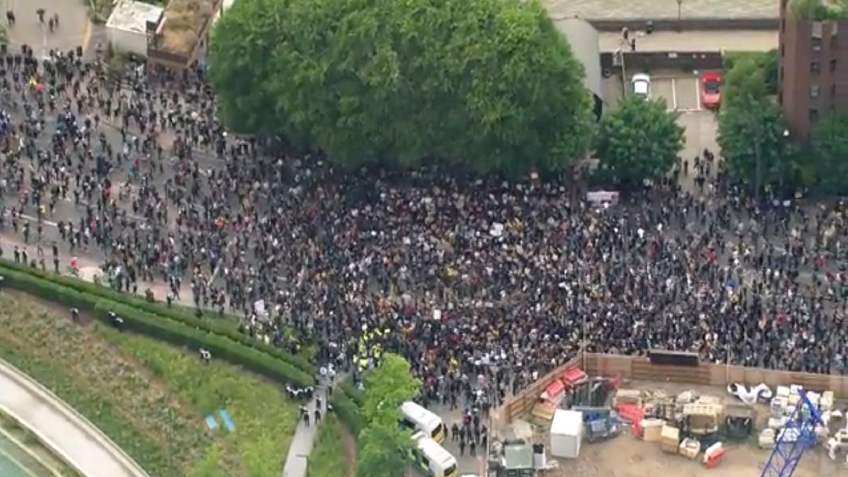 An aerial grab taken from video of protesters demonstrating outside the US embassy in London on Sunday. (AP/UK Pool)