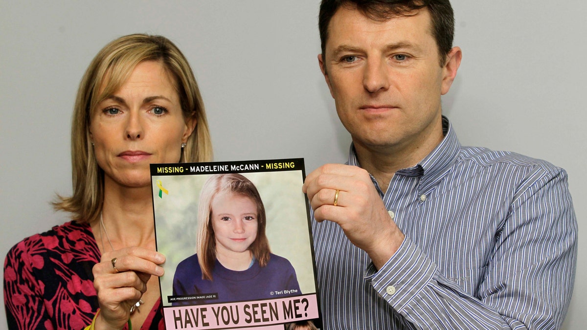 In this May 2, 2012 file photo, Kate and Gerry McCann pose for the media with a missing poster depicting an age progression computer-generated image of their daughter Madeleine at nine years of age.