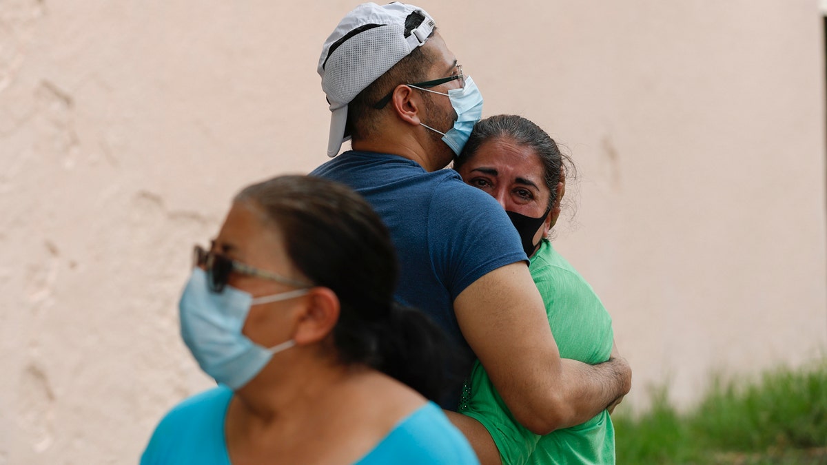 People embrace on he street as they wait for the all-clear to return to their apartment after an earthquake in Mexico City, Tuesday, June 23, 2020.