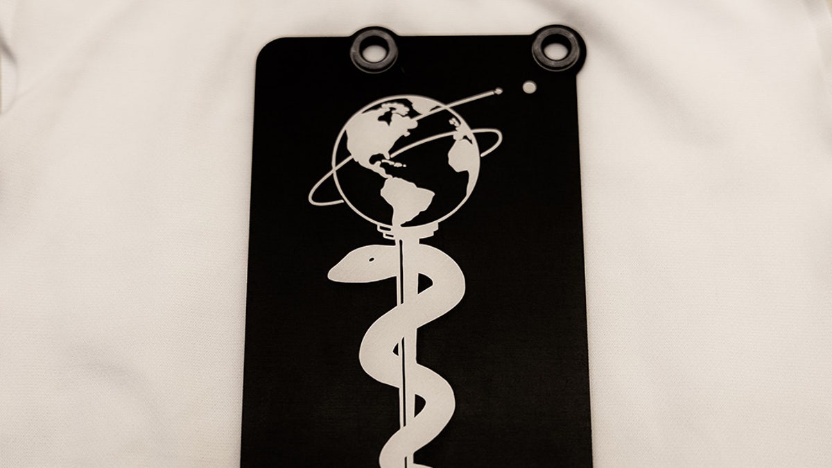 Attached to the Perseverance Mars rover, this 3-by-5-inch aluminum plate commemorates the impact of the COVID-19 pandemic and pays tribute to the perseverance of healthcare workers around the world.