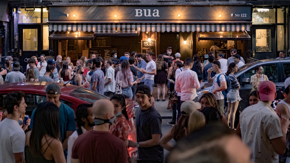 People drink outside a bar during the reopening phase following the coronavirus disease (COVID-19) outbreak in the East Village neighborhood in New York City, U.S., June 12, 2020. Picture taken June 12, 2020. REUTERS/Jeenah Moon