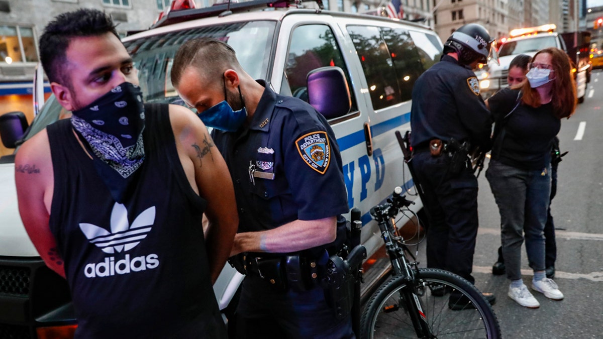 Protesters are arrested by NYPD officers for violating curfew beside the iconic Plaza Hotel on 59th Street, Wednesday, June 3, 2020, in the Manhattan borough of New York.(AP Photo/John Minchillo)