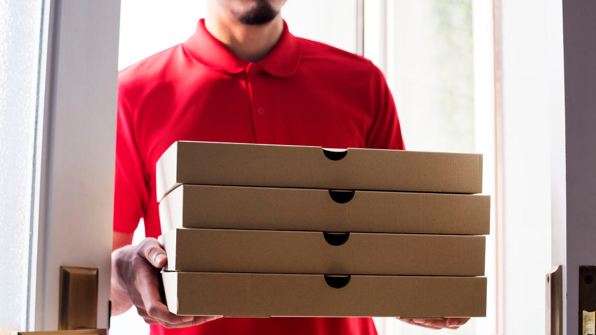 Man delivery pizza to customer