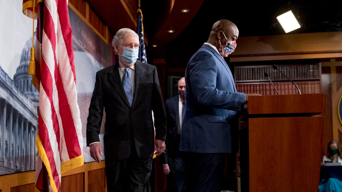 Senate Majority Leader Mitch McConnell of Ky., left, and Sen. Tim Scott, R-S.C., right, arrive at a news conference to announce a Republican police reform bill on Capitol Hill, Wednesday, June 17, 2020, in Washington. (AP Photo/Andrew Harnik)