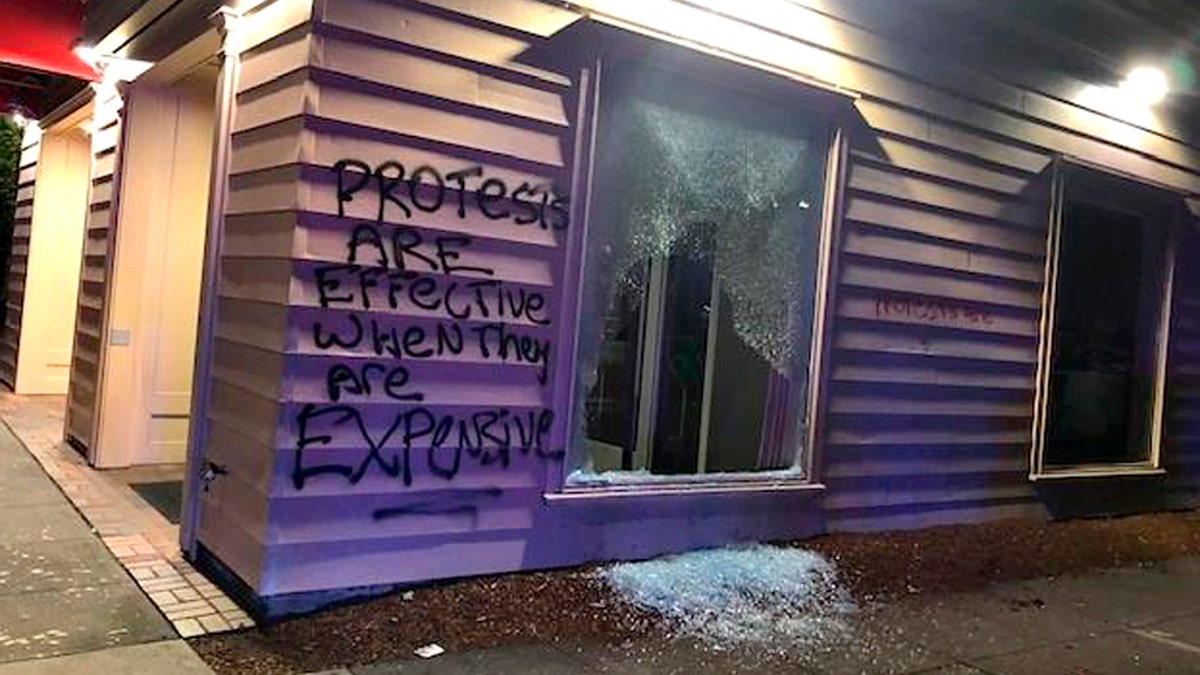 This Friday, June 26, 2020, photo released by the Portland Police Department shows damage after protests calling for an end to racial injustice and accountability for police in Portland, Ore. Some protesters set fire to a police precinct, vandalized businesses and tried to barricade police officers inside their station during a demonstration early Friday morning that ended with law enforcement using tear gas to disperse the crowd, authorities said. (Portland Police Department via AP)
