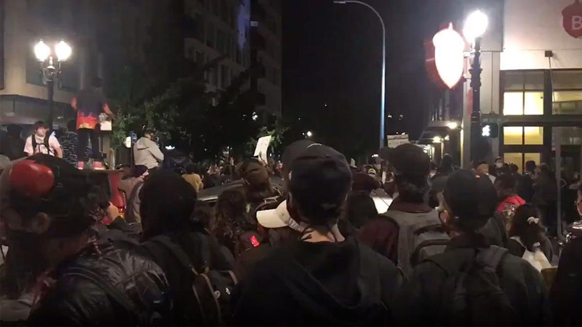 Hundreds of protesters chanting “Black Lives Matter” and “Hands up, don’t shoot!” were seen on video rallying outside Portland Mayor Ted Wheeler’s apartment late Wednesday night<br>