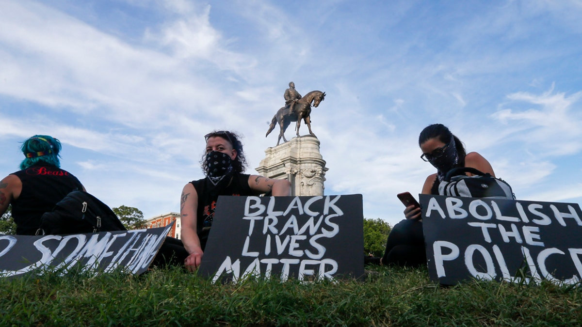 This Tuesday, June 2, 2020 file photo shows a part of a large group of protesters gather around the statue of Confederate General Robert E. Lee on Monument Avenue near downtown in Richmond, Va. (AP Photo/Steve Helber, File)