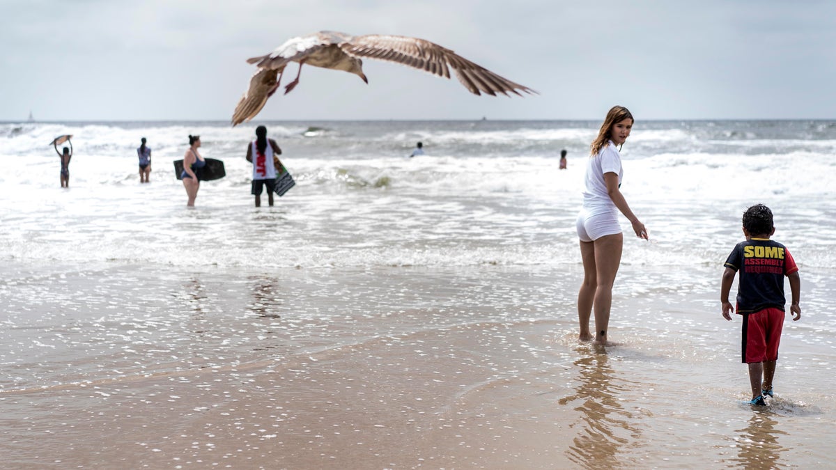 With social distancing guidelines enforced, crowds gathered on Mission Beach on Memorial Day weekend during the COVID-19 pandemic in San Diego, California. (Photo by Melina Mara/The Washington Post via Getty Images)