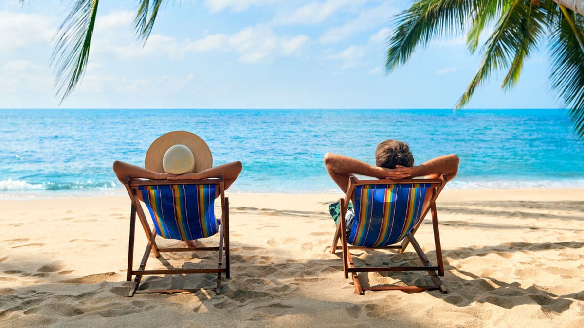 Couple relax on the beach enjoy beautiful sea on the tropical island