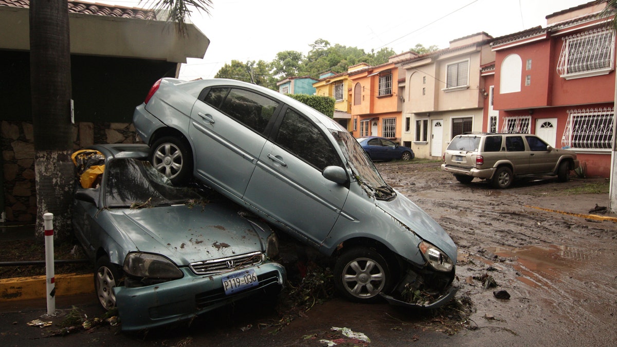 Vehicles stand damaged by an Acelhuate River flash flood at a neighborhood in San Salvador, El Salvador, May 31.