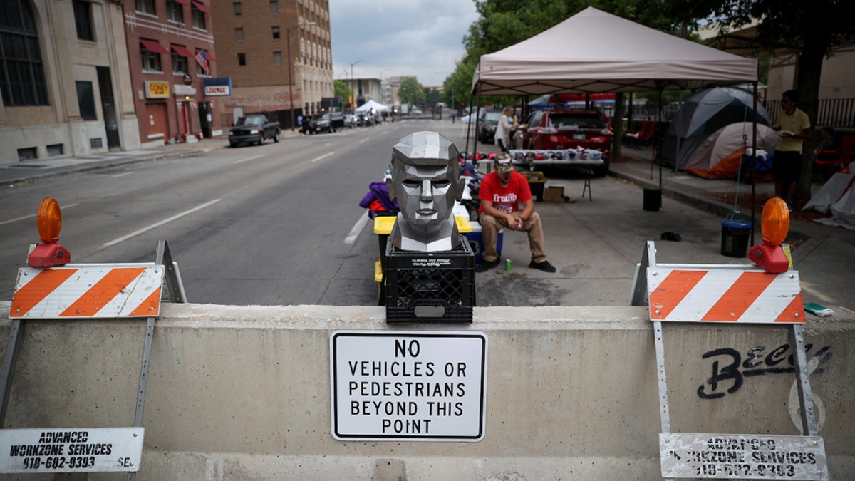 June 19: A metal bust of President Trump is on display outside the BOK Center as people line up to attend his campaign rally in Tulsa, Oklahoma. (Photo by Win McNamee/Getty Images)