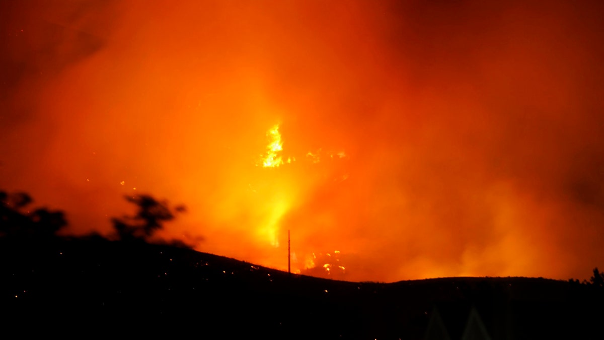 The Traverse Fire burns near homes in Lehi, Utah, Sunday, June 28, 2020.