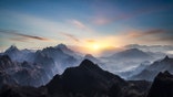 Aerial view of misty mountains at sunrise