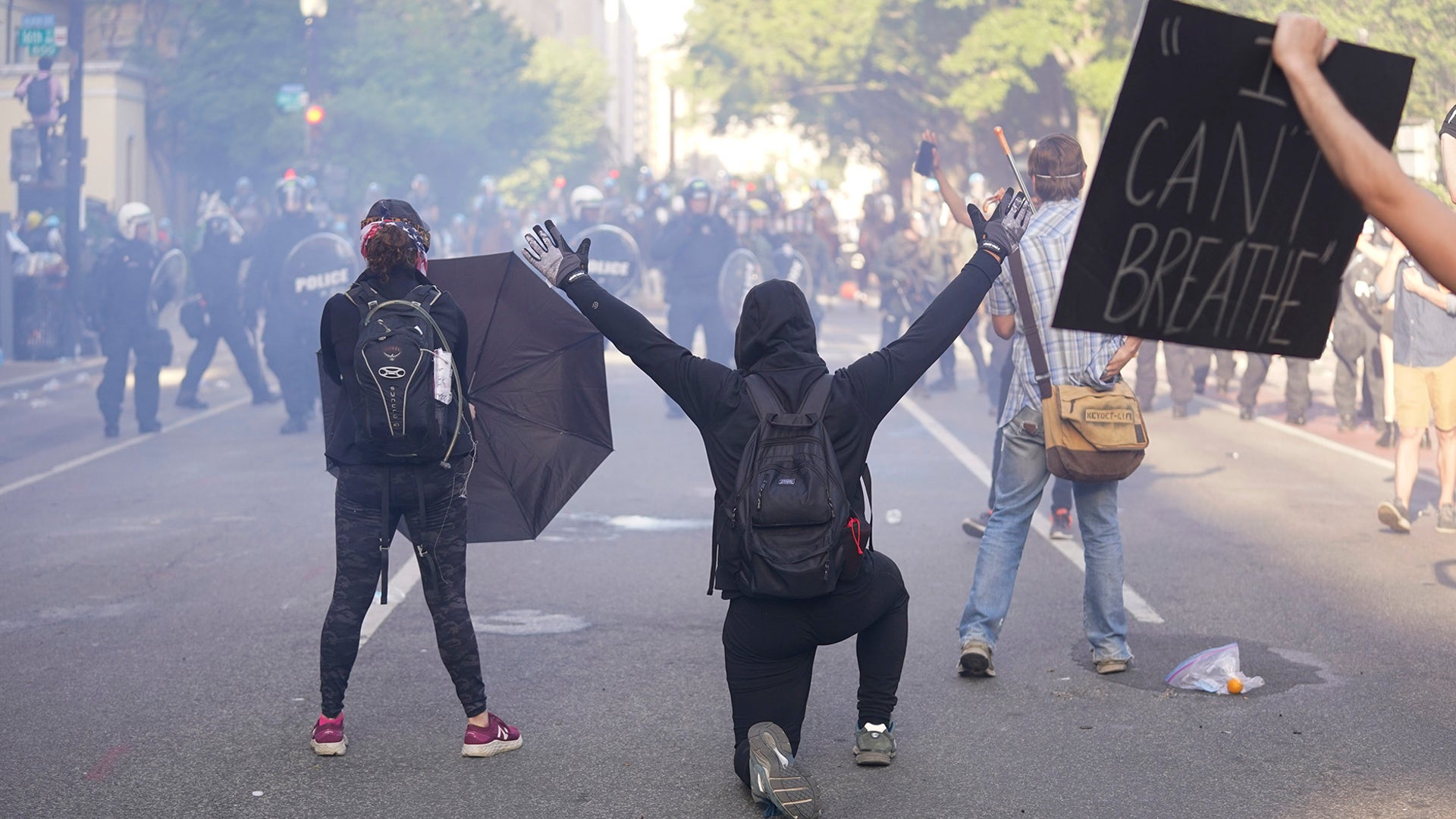 Demonstrators kneel in front of a line of police officers during a protest for the death of George Floyd near the White House in Washington, D.C., June 1, 2020.
