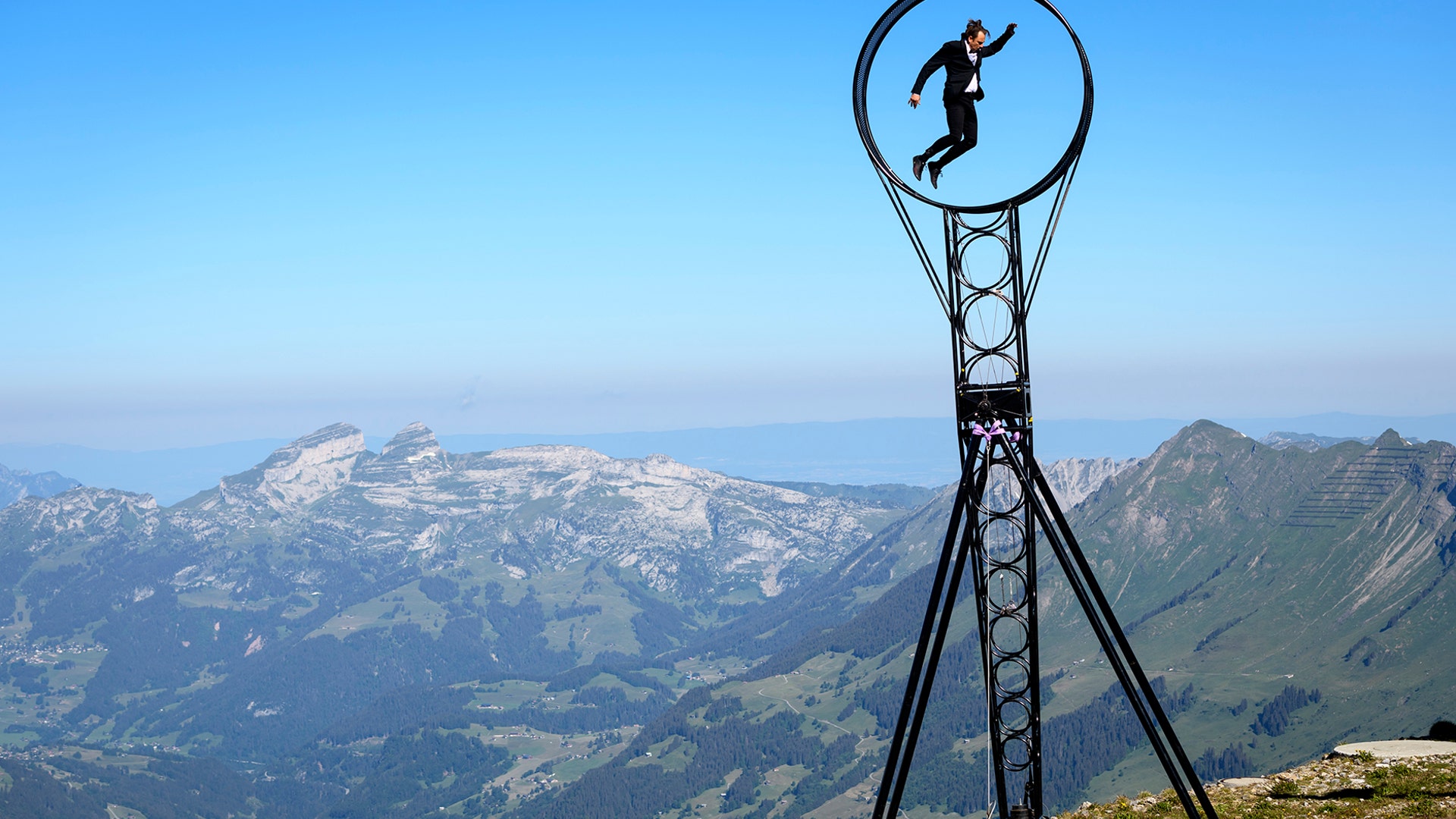 Switzerland's and Australian acrobatic artist Ramon Kathriner performs on a 'Wheel of Death' with the Swiss Alps in the background during the Glacier 3000 Air Show in the village Les Diablerets, Switzerland, June 23, 2020. 