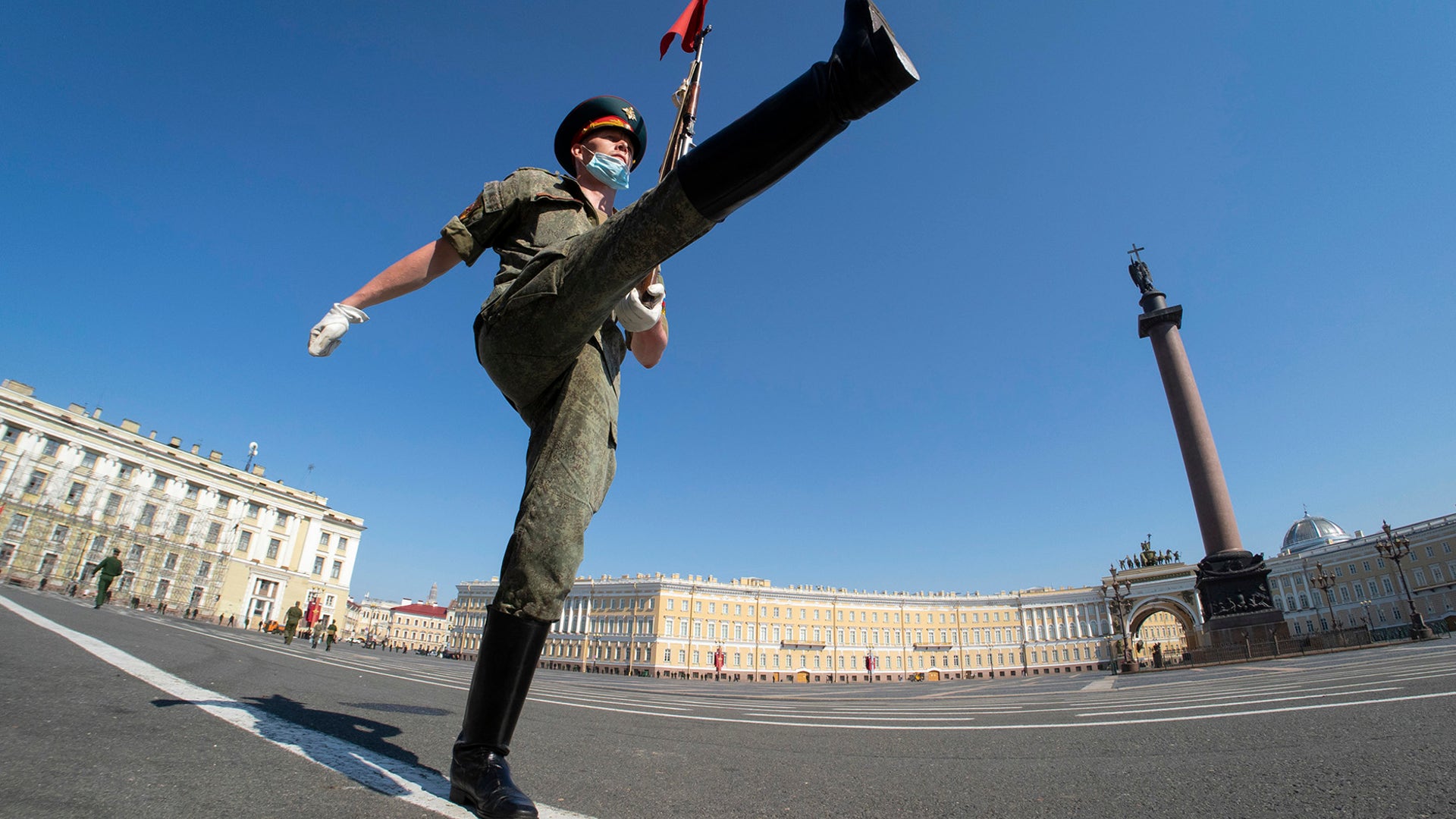 A Russian army soldier wearing a face mask to protect against coronavirus infection marches during a military parade rehearsal in St. Petersburg, Russia, June 17, 2020. 