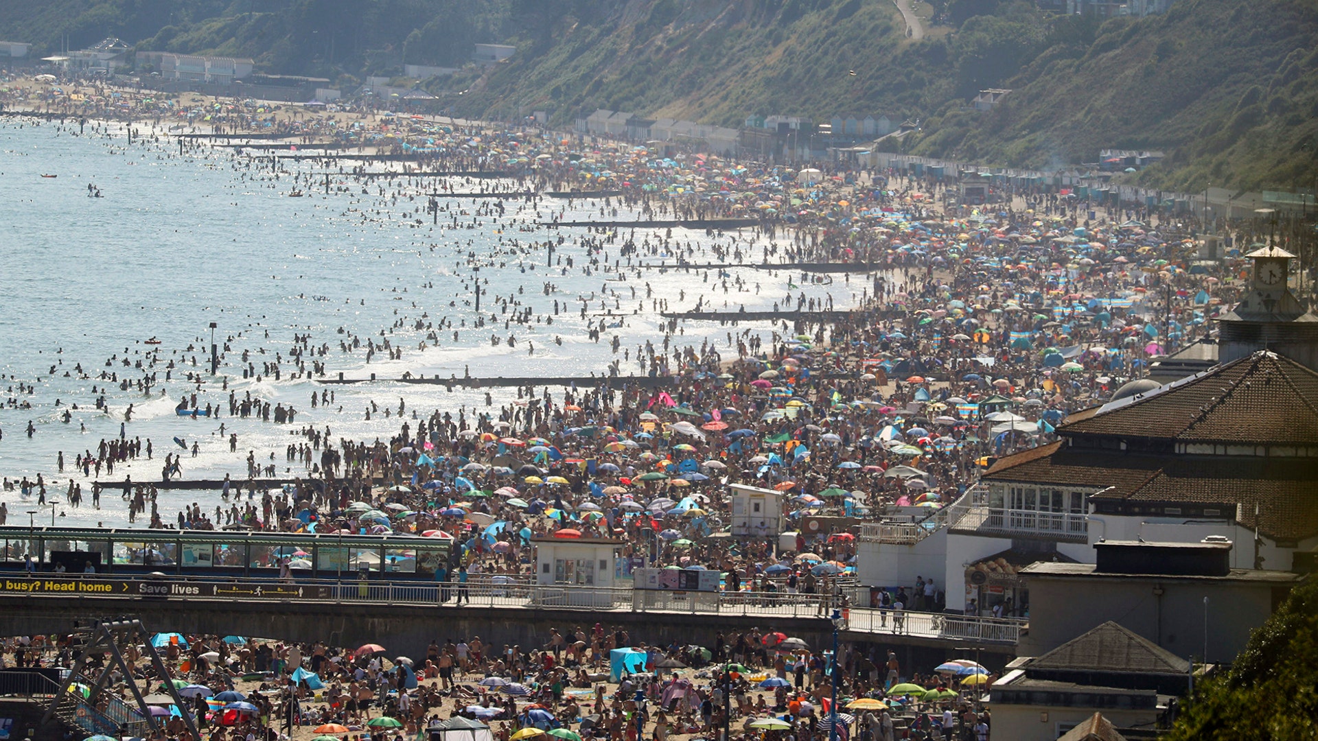 People are seen on the beach on the hottest day of the year, after an easing of social restrictions due to coronavirus, in Bournemouth, England, June 24, 2020. 