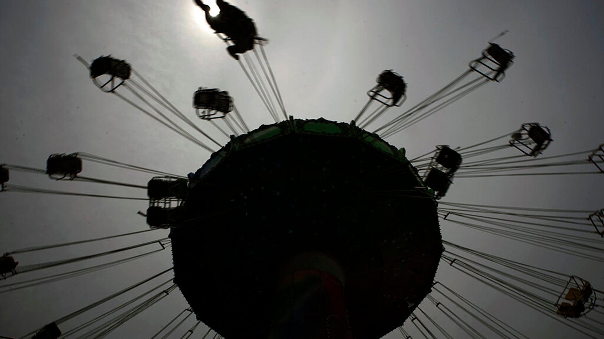 A visitor enjoys the swing ride at the Yomiuriland amusement park in Tokyo, June 16, 2020. 