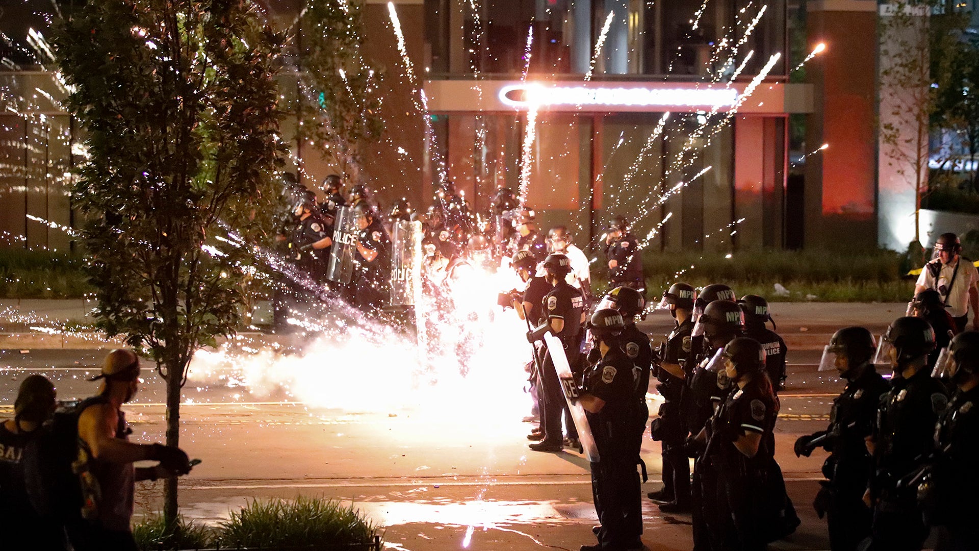 A firework explodes next to a police line as demonstrators gather to protest the death of George Floyd, near the White House in Washington, D.C., May 30, 2020.
