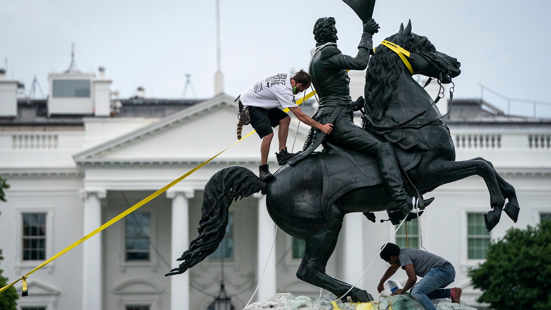 Protesters attempt to pull down the statue of Andrew Jackson in Lafayette Square near the White House in Washington, June 22, 2020. 
