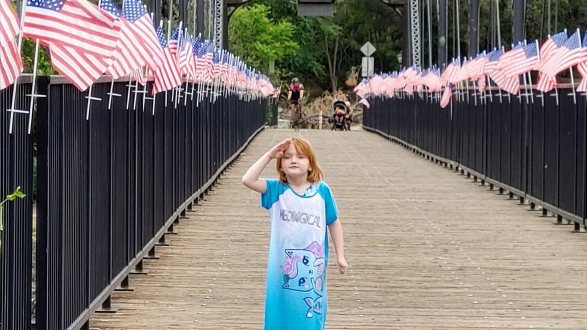 Walking over a bridge after a family trip to the lake, in Folsom, Calif. Our daughter Abigail had to stop and get a picture showing how she feels about America. We are a couple of proud parents!