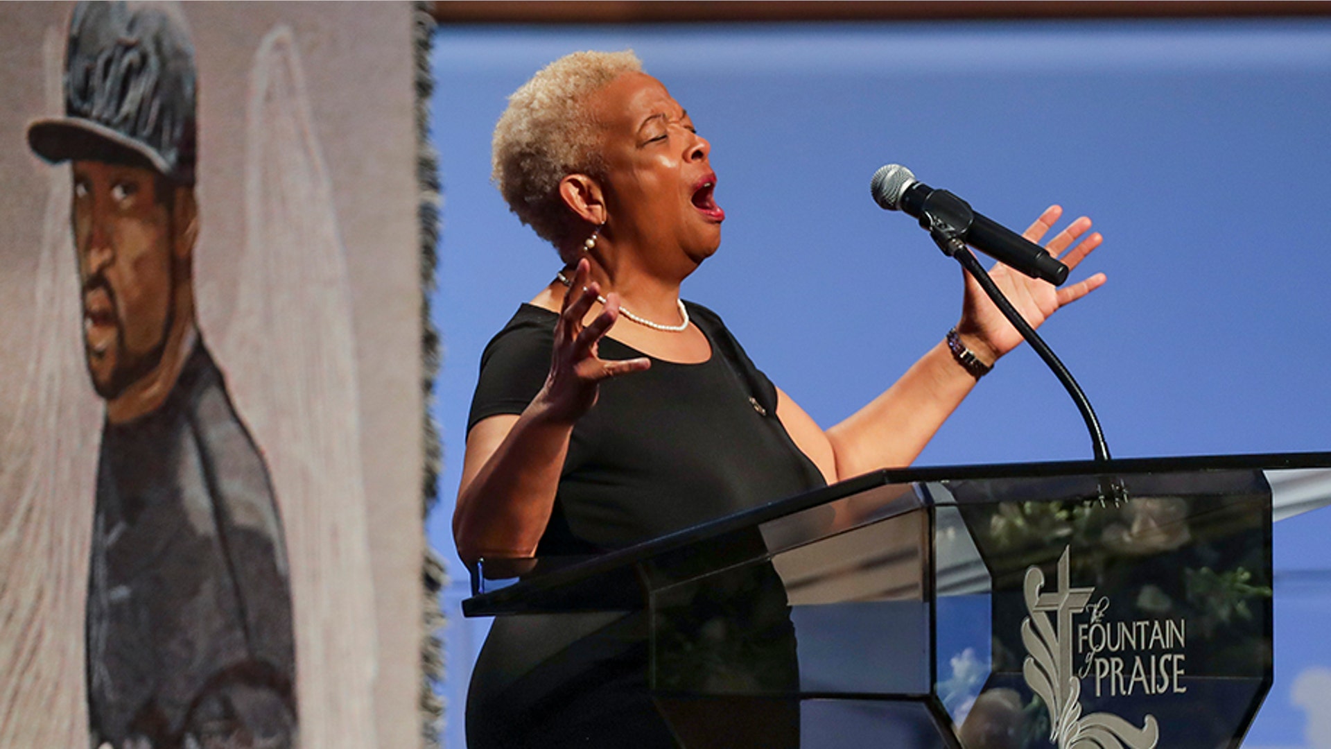 The Rev. Mary White praying during the funeral.