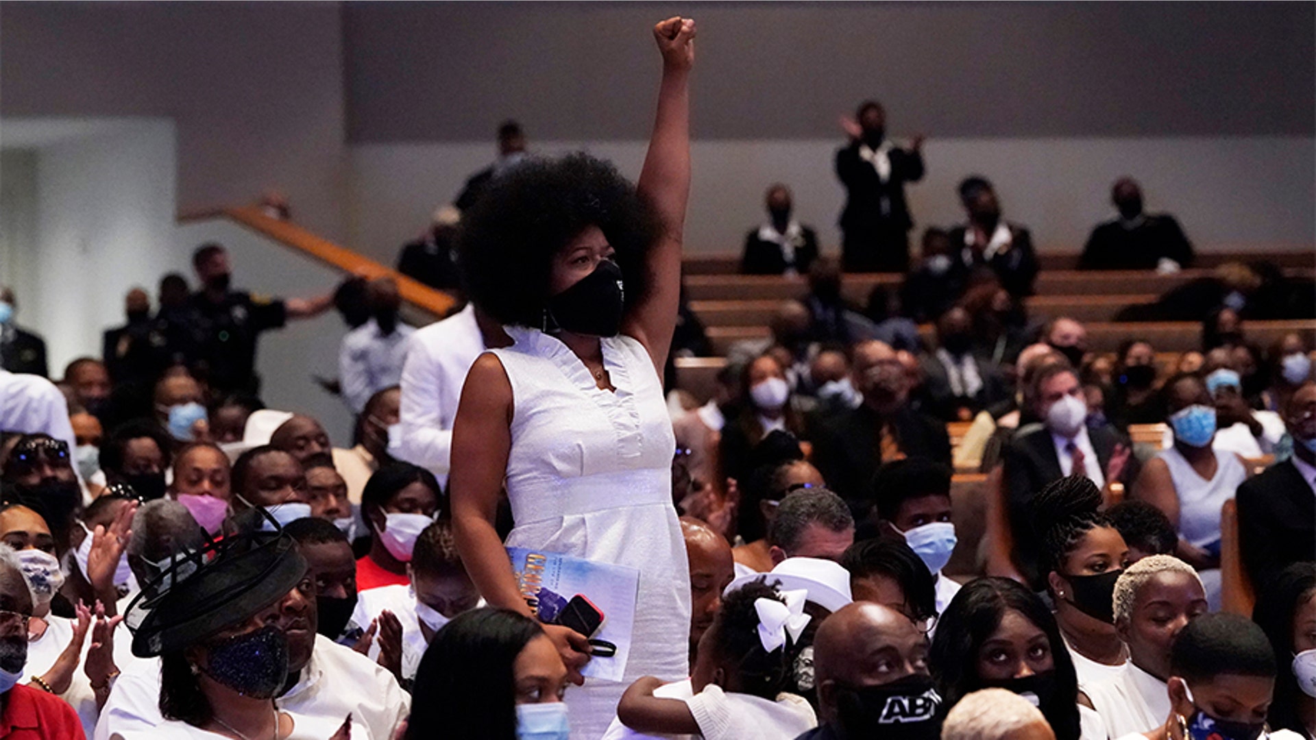 Family members standing up and reacting as the Rev. Al Sharpton gave the eulogy.
