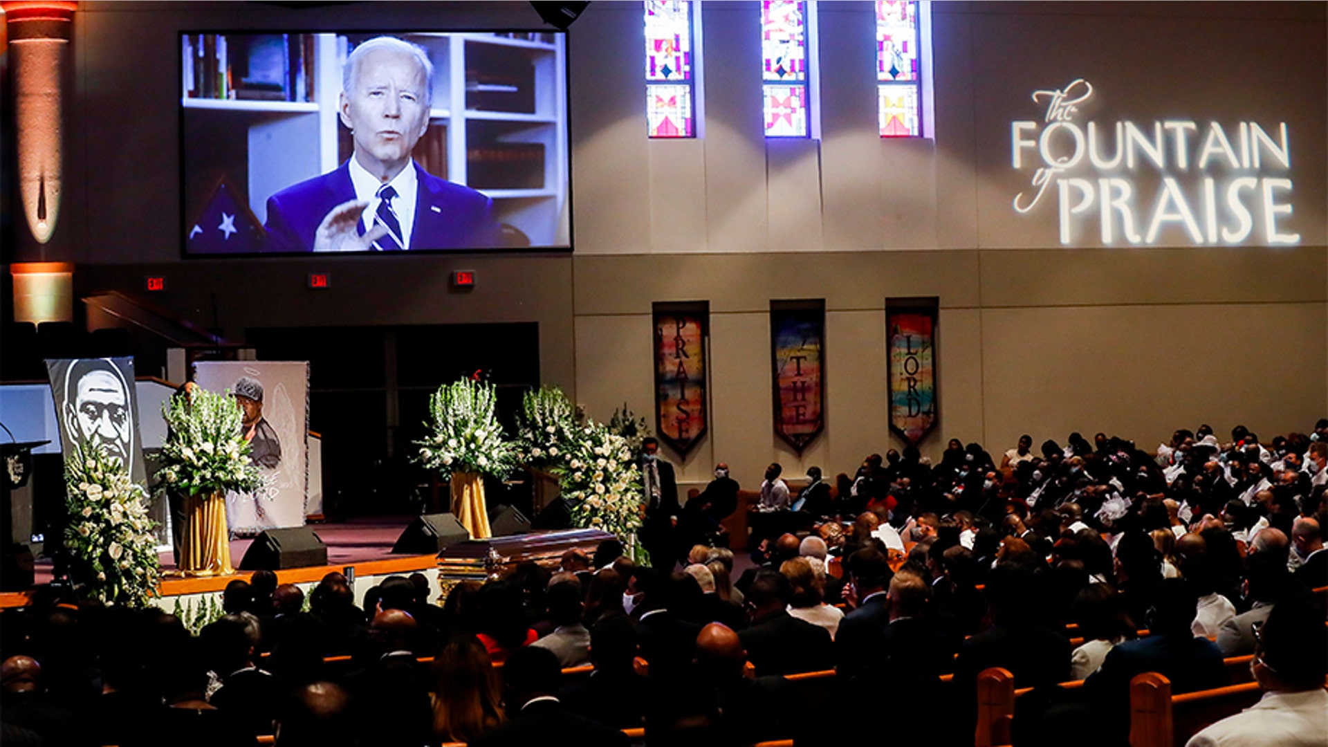 Mourners watching a video-recorded message by former Vice President Joe Biden. "No child should have to ask questions that too many black children have had to ask for generations: Why?" Biden said. "Now is the time for racial justice. That is the answer we must give to our children when they ask why."