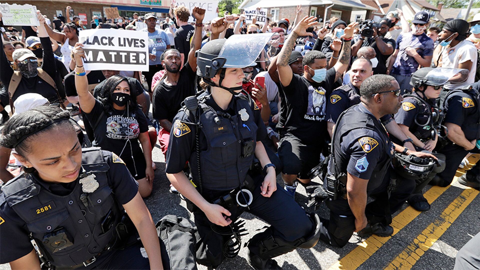 Cleveland police officers and protesters taking a knee together during a rally June 2 in Cleveland.