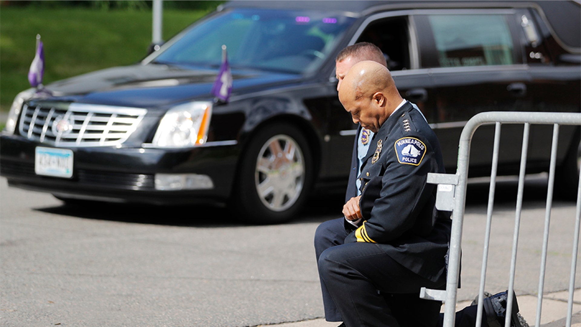 Police officers including Minneapolis Police Chief Medaria Arradondo, foreground, taking a knee as the body of George Floyd arrived before his memorial services in Minneapolis.