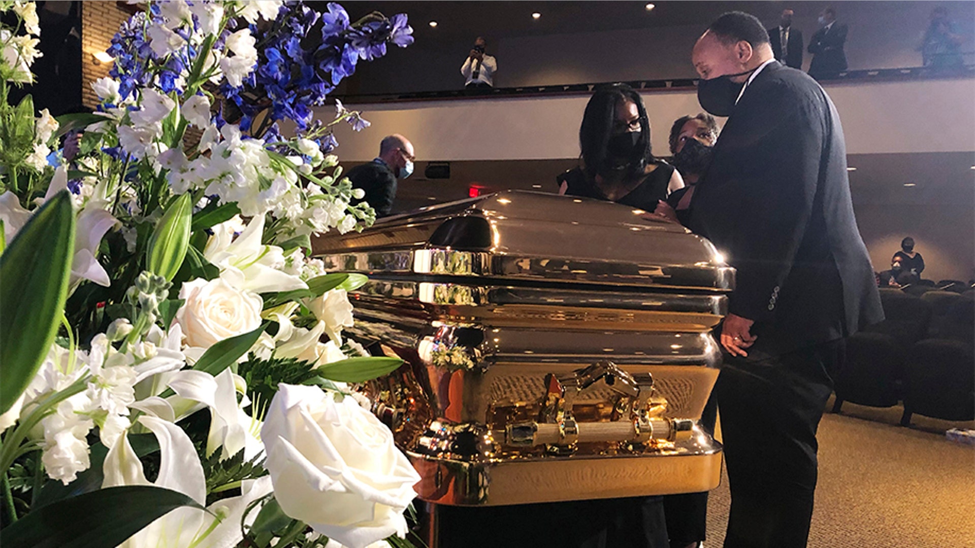 Martin Luther King III taking a moment by George Floyd's casket.