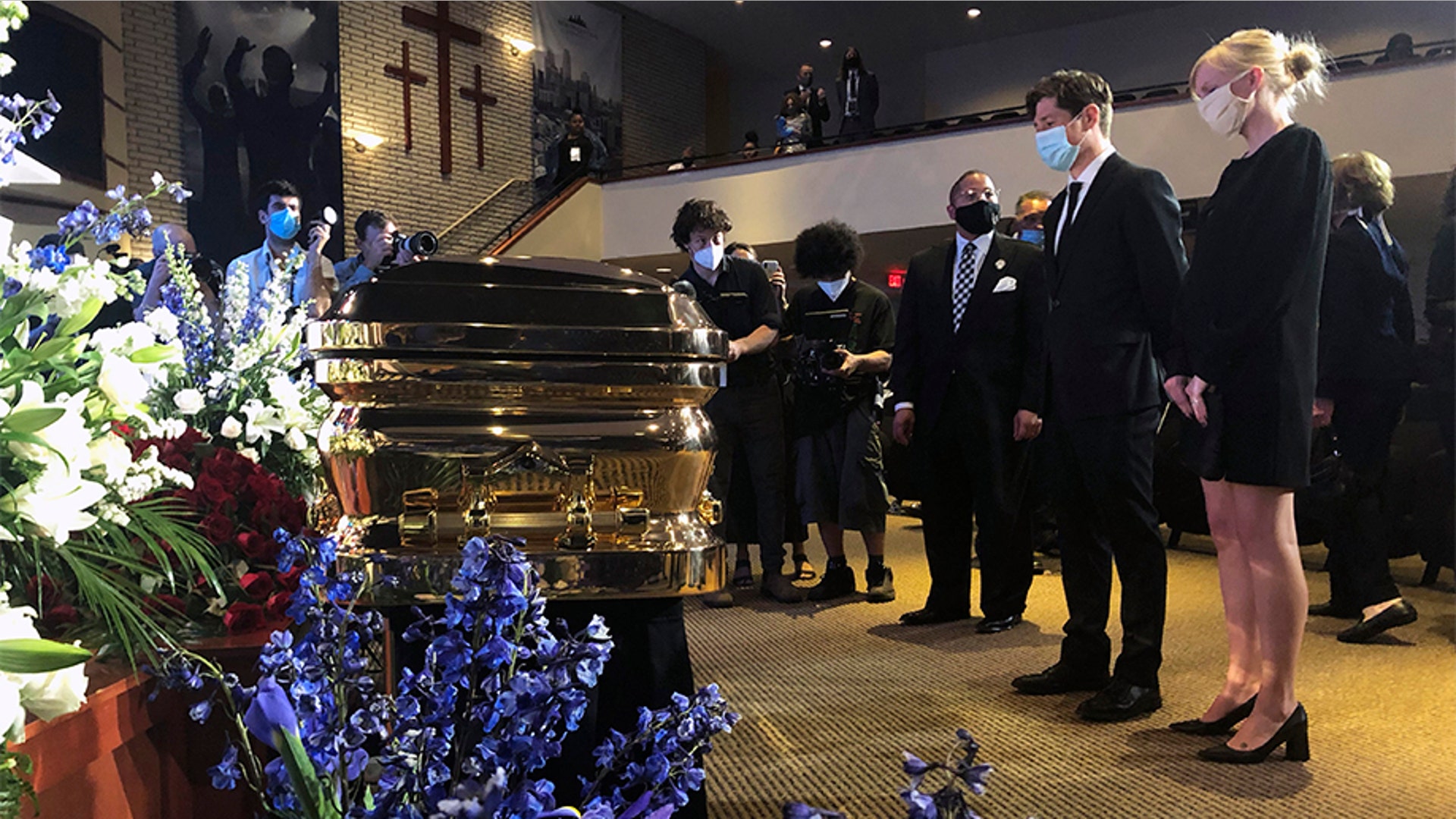 Minneapolis Mayor Jacob Frey, second from right, and First Lady Sarah Clarke, right, pausing before George Floyd's casket.