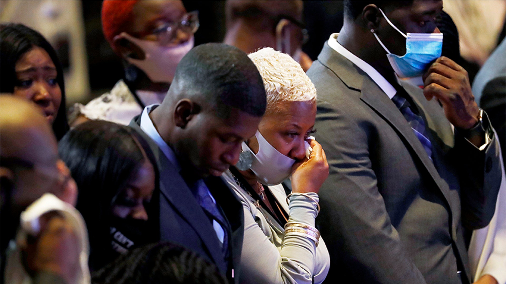 Shareeduh Tate, second from left, reacting during an 8:46 pause in the memorial service.