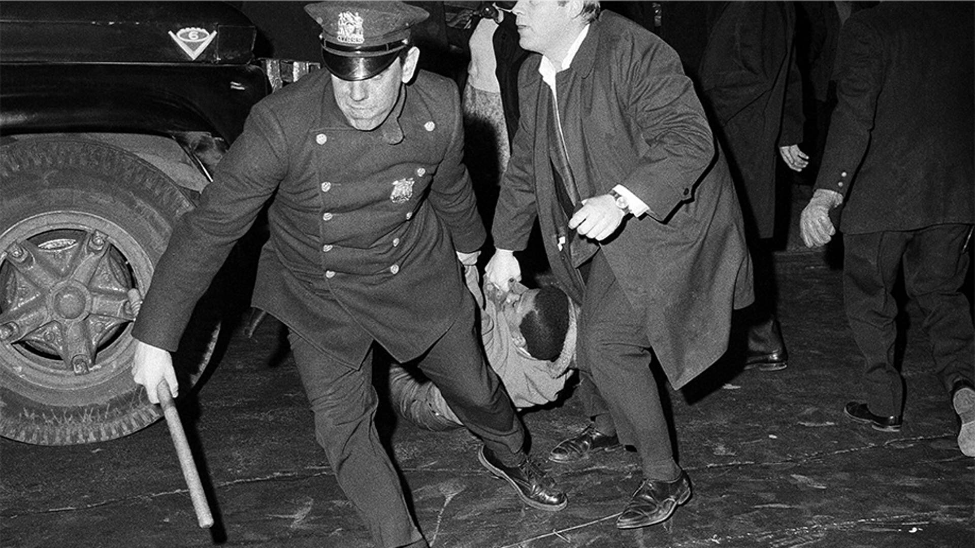 Police dragged away one person from a store after he smashed a window in New York City's Times Square on April 5, 1968, as disturbances spread over many sections of New York City in the wake of the assassination of Martin Luther King.