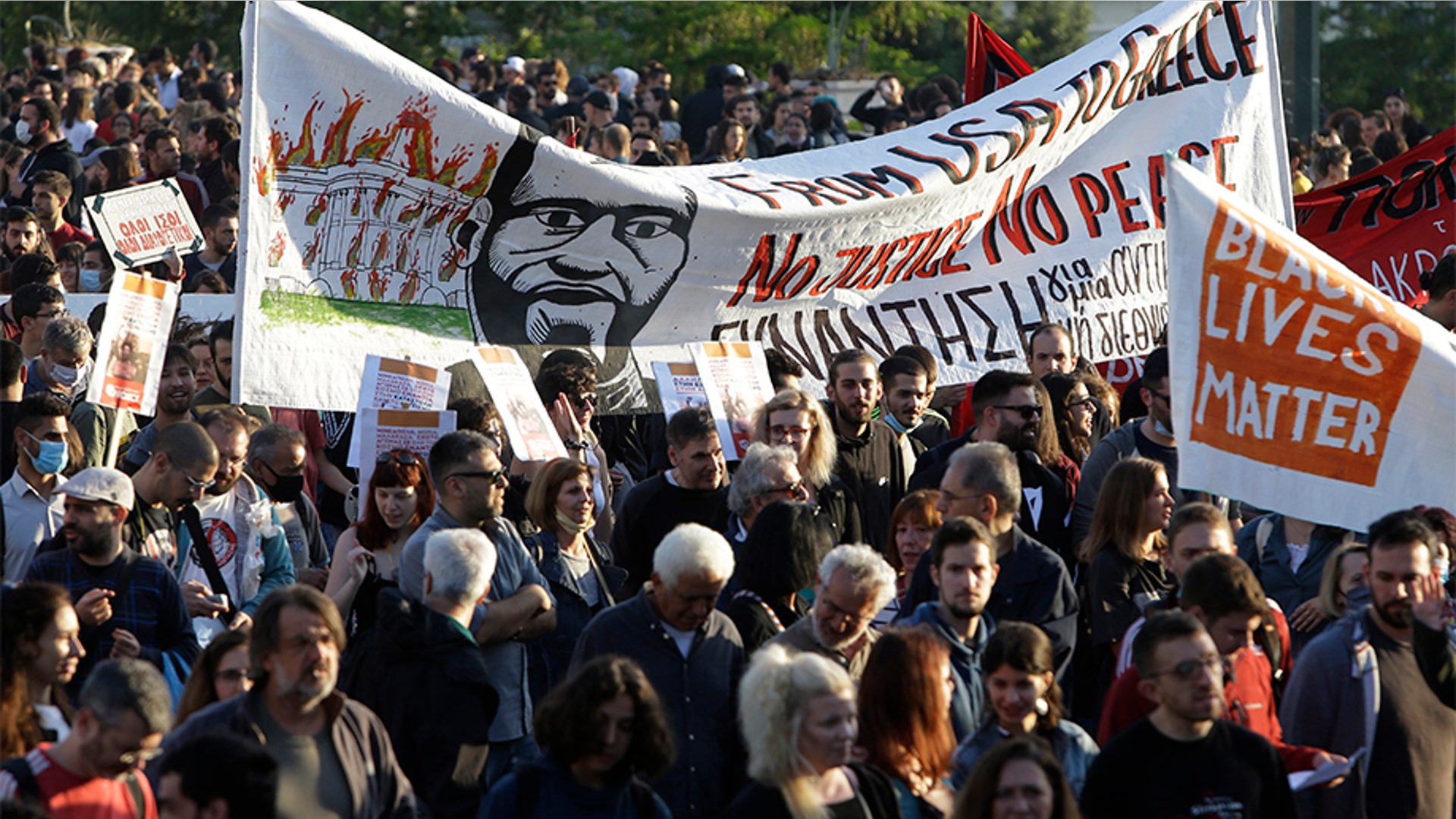 Protesters, holding a banner depicting George Floyd, marching past the Greek Parliament as they headed toward the U.S. Embassy in Athens.