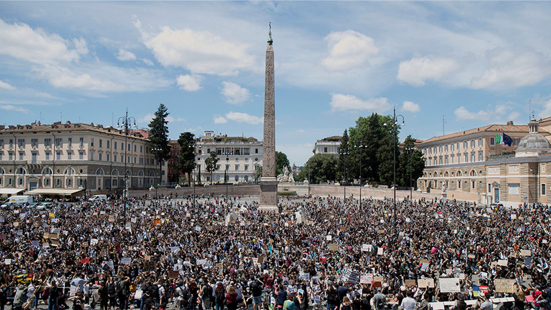 In Rome's sprawling People's Square, a rally was noisy but peaceful, with the majority of protesters wearing masks.