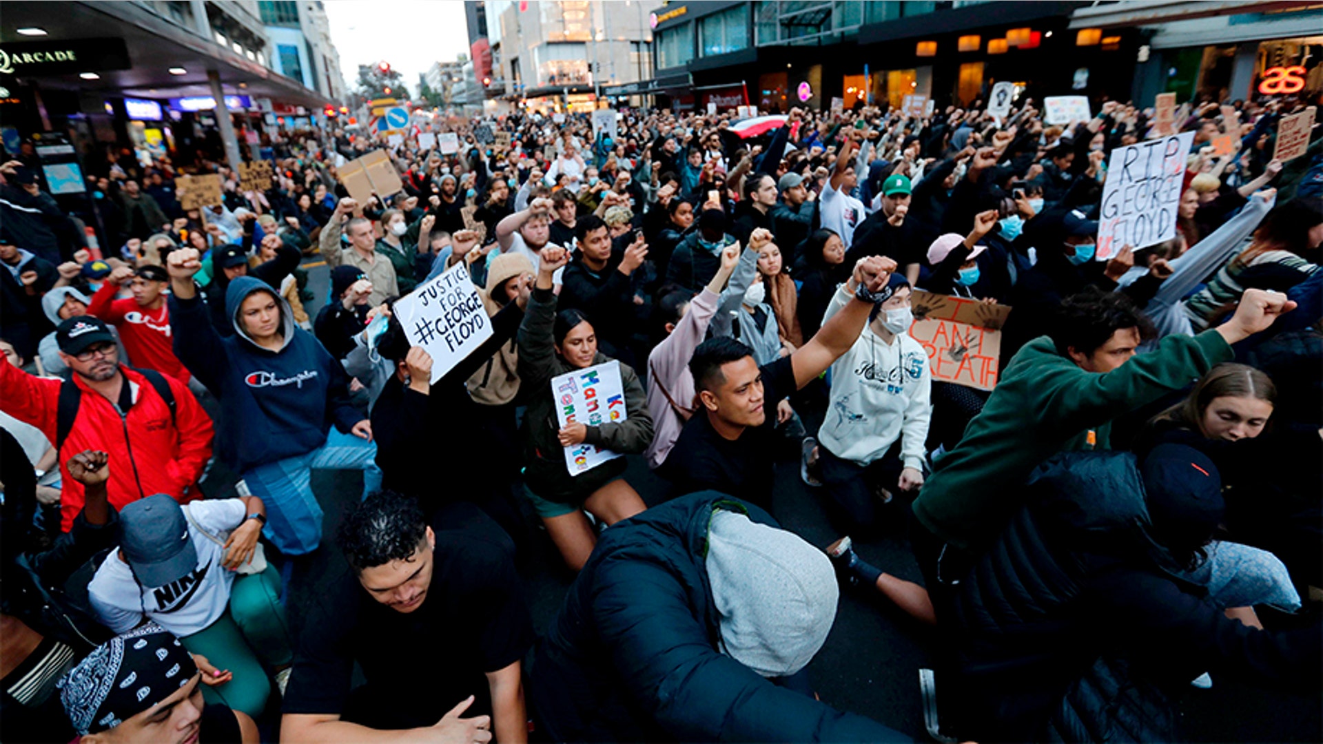 Demonstrators holding placards in central Auckland, New Zealand.