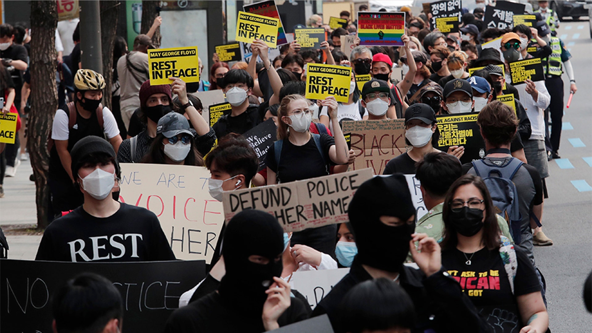 People marching to protest during a solidarity rally in Seoul, South Korea.