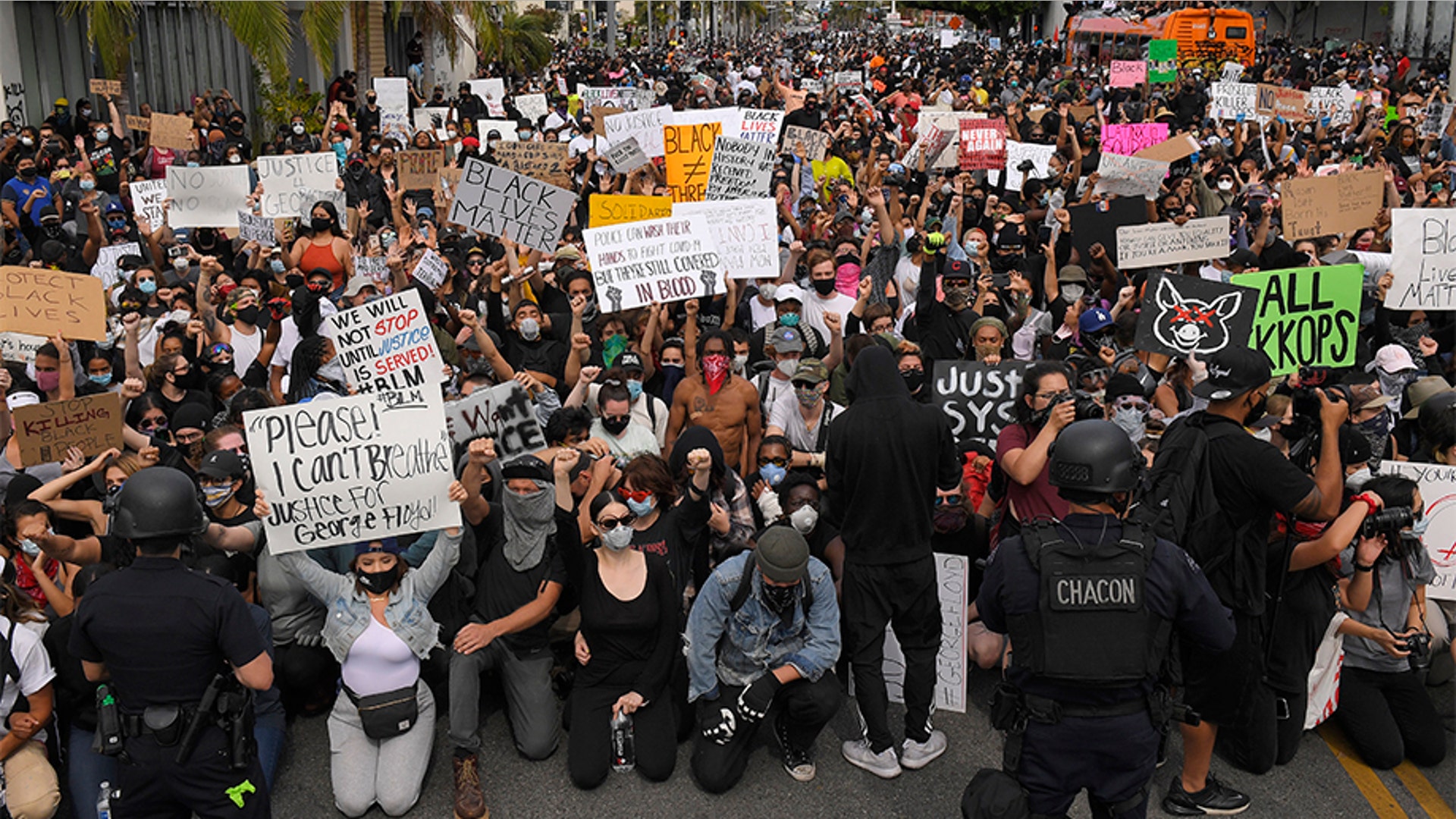Demonstrators kneeling in front of the police in Los Angeles.