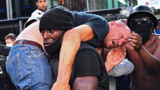 Black protester carries white man through angry crowd to safety to 'stop someone from being killed'