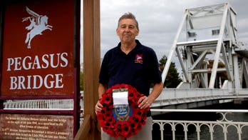 One man lays wreaths in Normandy on unusual D-Day hit by coronavirus