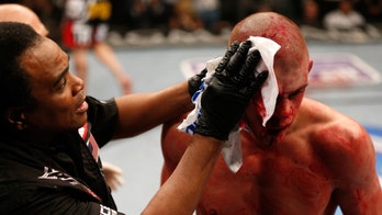 UFC launches investigation after cut man seen wearing QAnon symbols during fight