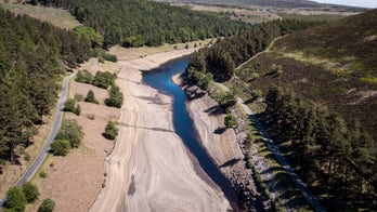 Dramatic images show how huge reservoir dwindled to a tiny stream in heat wave