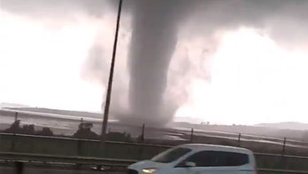 Waterspout roars across lake in Turkey as torrential rains lash Istanbul, killing Syrian refugee